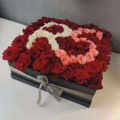 A personalized flower box with the initial 'R' created using a mix of white, pink, and red roses. I can customize these arrangements with any letter or design.
