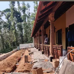 A look at the modernization in progress for an estate bungalow in Sakleshpur. We are preserving the traditional wooden pillars and veranda while updating the structure and preparing the surrounding landscape for a contemporary garden design.