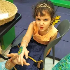 Even our little Radhas get in on the fun with beautiful peacock feather tattoos. It's all about celebrating our culture with joy and creativity.