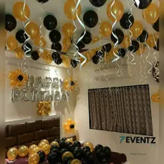 For a sophisticated and modern look, I use a black and gold color scheme. This birthday room setup includes balloons on the ceiling and bed, along with matching streamers and foil letters.