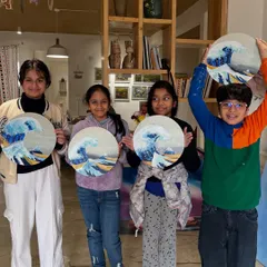 A group of friends showing off their beautiful paintings inspired by 'The Great Wave'. It’s amazing to see how each child adds their own unique touch to a classic masterpiece.