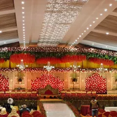 We transform grand venues into breathtaking scenes for your special day. This wedding reception setup features a magnificent floral stage, dramatic lighting, and seating for hundreds of guests, all meticulously planned to create a royal and elegant atmosphere.