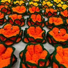 A close-up of the orange lotus coasters from the bulk order of 100. Each one is crafted with the same attention to detail, no matter the quantity.