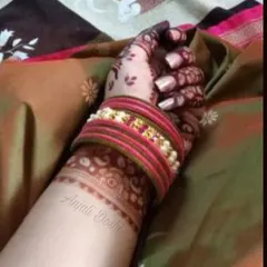 Stain alert. This photo captures the deep, beautiful color of the mehendi against the wrist, highlighting the delicate cuff pattern.