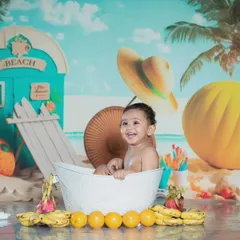 This little one is having a great time in his fruity beach bath.