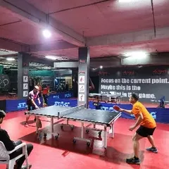 Another angle of the tournament in full swing. The setup includes professional barriers and umpire seating for each table.