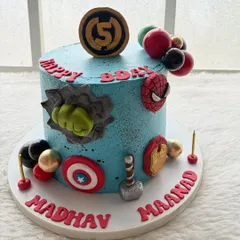 A superhero party isn't complete without a superhero cake! This one was for a huge Marvel fan, featuring all the Avengers' symbols like Hulk's fist, Captain America's shield, and Thor's hammer, all handcrafted by me.