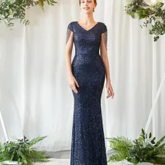 Look effortlessly chic at your next reception or formal event in this navy blue sequin gown. The figure-hugging silhouette and delicate tassel details on the shoulders add a touch of modern glamour.