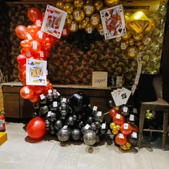 For a fun Diwali card party, I created this unique balloon arch. The design uses red, black, and gold balloons with oversized playing card cutouts. This kind of thematic decor is perfect for creating a memorable party atmosphere.
