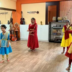 A group of young girls practicing their Kathak formations in the studio. Group practice helps students learn synchronization and teamwork.