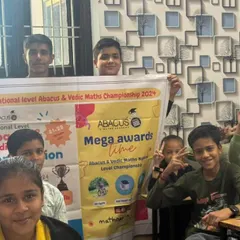 A close-up of the Dausa team with their competition banner. The victory signs show their confidence and team spirit.