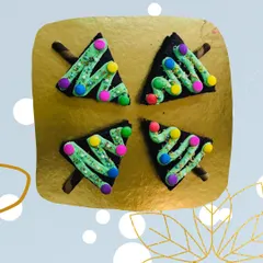 Four of my Christmas tree brownies arranged on a platter. They are a popular item for holiday orders and office parties, offering a fun, festive twist on a classic fudgy brownie.