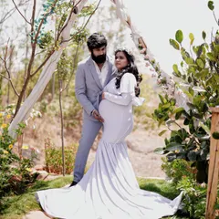 Capturing the quiet, beautiful moments of waiting. This elegant white mermaid-style maternity gown is designed to be both comfortable and flattering, perfect for a gentle, nature-filled photoshoot.