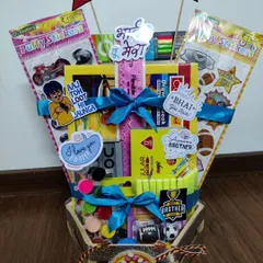 Here is a closer look at the stationery-filled Rakhi hamper for kids. You can see the variety of items included, from paints and stickers to a drawing book, offering a creative alternative to traditional snack baskets.