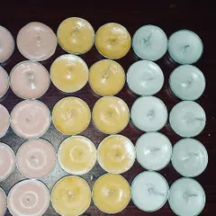 More of my colorful tealights laid out, showing the different wax options available. These are great for creating patterns or adding subtle color to your decor.