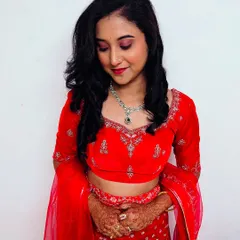 A closer look at the reception makeup. I used a shimmery pink eyeshadow and a matching lip color to complement her red lehenga, creating a cohesive and glamorous party look.