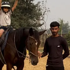 Here, a young rider practices a confidence building exercise under the watchful eye of our instructor. Each session is a safe space for personal growth and achievement.