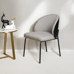 A similar chair design shown with a textured fabric upholstery. This demonstrates the variety of finishes available, all offering plush seating and a modern, ergonomic design suitable for any season.