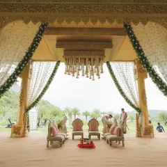 A mandap fit for royalty. This grand, intricately carved structure, adorned with delicate floral garlands, created a breathtaking focal point for a destination wedding in Udaipur.