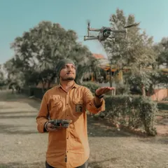 Here I am with my DJI Air 2S drone, my trusted partner for capturing stunning aerial views. It's important for you to see the person behind the controls, ready to bring your vision to life.