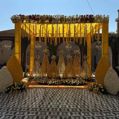 Another angle of our yellow-themed Haldi mandap. The large floral cones at the front add a unique and grand touch to the traditional setup.