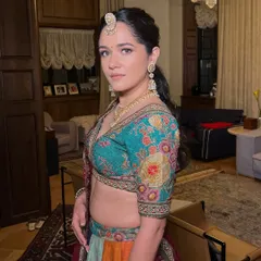 A vibrant and colorful look for a Mehendi or Sangeet. The makeup is fresh and fun, with a focus on glowing skin and a simple hairstyle.