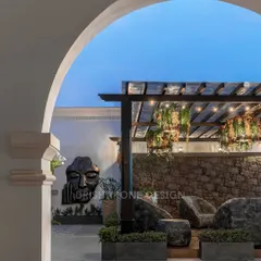The rooftop terrace at dusk, with the pergola lights and wall art creating a magical ambiance. This space is perfect for evening gatherings or simply unwinding under the stars.