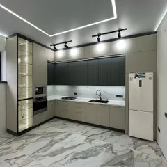 A showcase of our modern kitchen designs, this space combines functionality with sleek aesthetics. We used a dual-tone scheme with matte black and beige cabinets, a marble-patterned backsplash, and integrated profile lighting for a clean, contemporary look.