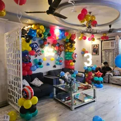 A wide view of the Marvel-themed living room transformation, showing how our decorations fill the space with balloon clusters on the ceiling and multiple character features.