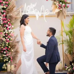 Capturing the moment he got down on one knee. This rooftop proposal combined boho-chic pampas grass arrangements with a modern "You + Me" neon sign, creating a stylish and personal setting.
