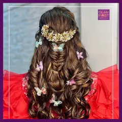 A whimsical and romantic hairstyle with soft waves and butterfly accessories. This is a dreamy look for a daytime event or a pre-wedding photoshoot.