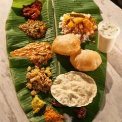 Another angle of the banana leaf meal, showing the authenticity and richness of the spread.