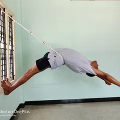 Viparita Dandasana (Inverted Staff Pose) in the ropes. This is an advanced backbend that creates a deep arch in the entire spine. The ropes provide the necessary support to hold the pose safely.