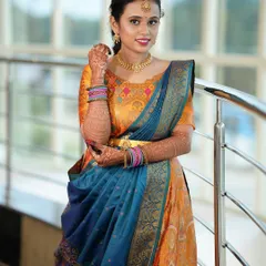 A smiling portrait of Yoshitha, showing off her colorful outfit and the subtle yet glowing makeup look.