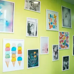 Our Wall of Joy! This wall is filled with happy pictures and art, reflecting the cheerful atmosphere of our play cafe.