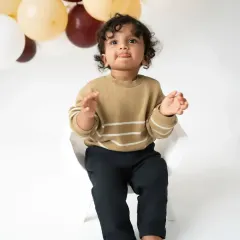 A moment of quiet curiosity. Even the thoughtful expressions are precious, showing a different side of your baby's personality during their sitter photoshoot.