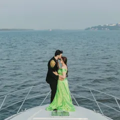 An intimate and cinematic moment on the bow of a yacht in Goa. The vast sea behind them and the tender embrace create a feeling of being in their own world.