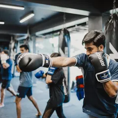 A line of fighters practices their jabs, the most important punch in boxing. We drill the basics until they become second nature.