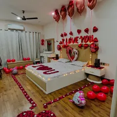 An angled view showcasing the scale of the room decoration. We cover the floor with balloons and create a beautiful heart shape with rose petals, making the entire space feel like a private celebration.