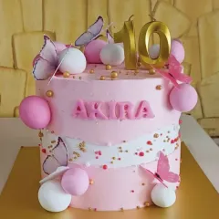 A dreamy butterfly cake for a 10th birthday. The soft pink frosting, delicate edible butterflies, and touches of gold create a whimsical and elegant design perfect for a special milestone.