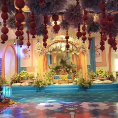 The focal point of our 'Moroccan Nightfall' event. The couple's seating was set under a rustic thatched canopy, with a backdrop of vibrant blue and orange patterns and a ceiling full of hanging pampas and cane lamps.
