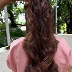 A close-up of the styled curls, showing how the light catches the different tones in her hair.