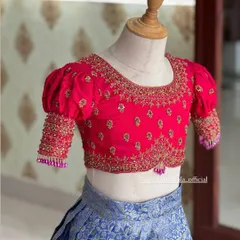 Another close-up of the pink blouse, showing the detailed embroidery on the neckline and sleeves.
