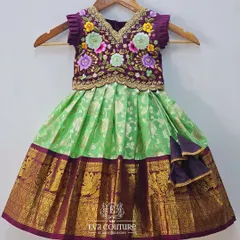 A beautiful blouse with heavy, multi-color floral maggam embroidery. The intricate threadwork on the purple base is highlighted with gold details, perfect for a designer lehenga.