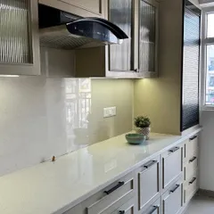 A close-up of the kitchen countertop, showing the under-cabinet lighting that provides excellent task lighting and highlights the clean finish of the cabinetry.