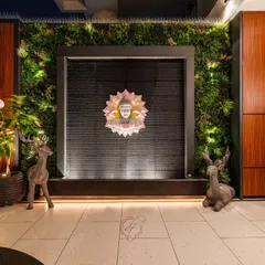 The focal point of the terrace is this serene Buddha water feature, framed by a lush green wall. The gentle sound of water and the soft lighting make it a perfect spot for meditation and relaxation.
