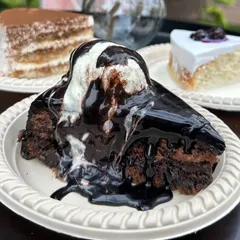 For the ultimate chocolate lover, we present our Chocolate Overload pastry. This decadent slice features a rich chocolate cake base, generously topped with chocolate sauce and a scoop of vanilla ice cream for a truly indulgent experience.