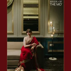 A stylish, editorial portrait titled "BRIDE OF THE MO'." The bride is seated on a sofa in a modern, well-lit room in Jammu, her red saree creating a bold statement.