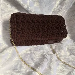 This clutch is made with thick T-shirt yarn, giving it a modern and substantial feel. It's a great statement piece that is also very durable.