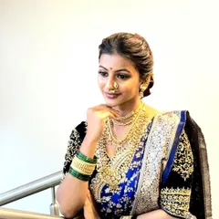 A close-up of this stunning Maharashtrian bride. The blue and gold Navari is complemented by traditional jewelry, and the drape is styled for a regal and timeless look.